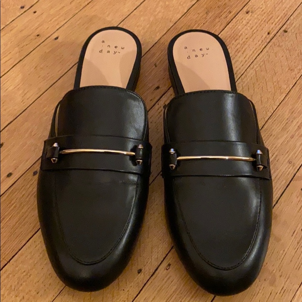 Black loafers with gold details